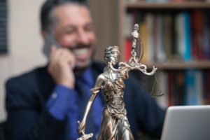Lady Justice and Happy Lawyer behind it